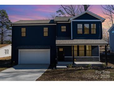 Two-story house with dark blue siding, white garage door, and a stone accent at 619 Norland Ave, Kannapolis, NC 28083