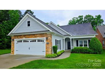 Charming one-story home featuring a stone and siding facade, attached garage, and beautifully landscaped front yard at 629 Cordova Ct, Salisbury, NC 28146