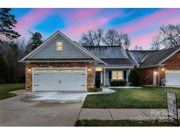 One-story home with gray siding, stone accents, and a two-car garage at 629 Cordova Ct, Salisbury, NC 28146