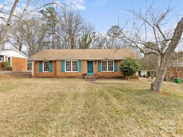 Brick ranch house with teal shutters and a spacious lawn at 6439 Montpelier Rd, Charlotte, NC 28210