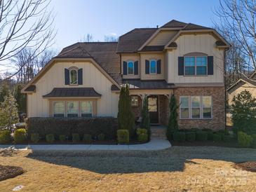 Two-story home with brick and siding accents, landscaping, and a large front yard at 680 Chase Ct, Fort Mill, SC 29708