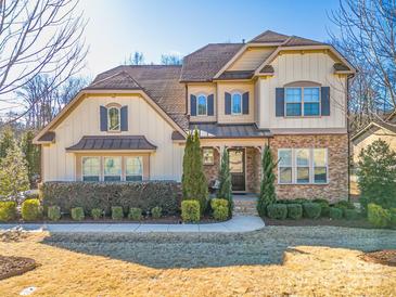 Charming two-story home with a manicured lawn and professionally landscaped front yard at 680 Chase Ct, Fort Mill, SC 29708