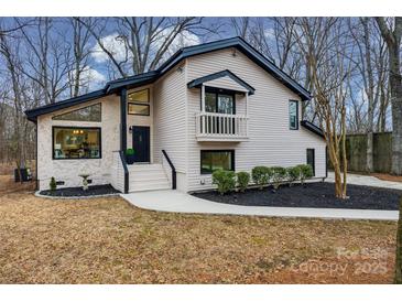 Updated two-story home with stone accents and a landscaped yard at 7137 Windyrush Rd, Charlotte, NC 28226