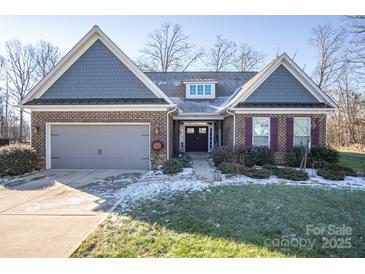 Brick ranch home with gray shake accents, 2-car garage, and landscaped yard at 7236 Albemarle Dr, Denver, NC 28037