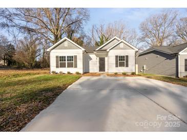 Newly built home with gray and white exterior, a driveway, and landscaping at 1420 Beechwood Dr, Gastonia, NC 28052