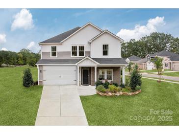 Two-story house with gray and white siding, a two-car garage, and landscaping at 1420 Windy Park Dr, Stanley, NC 28164