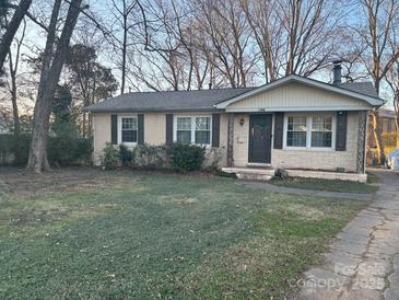 Brick ranch house with a spacious lawn and mature trees at 1500 Collier Ct, Charlotte, NC 28205