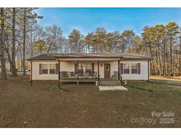 House exterior featuring a covered porch and well-manicured lawn at 1957 Beth Haven Church Rd, Denver, NC 28037