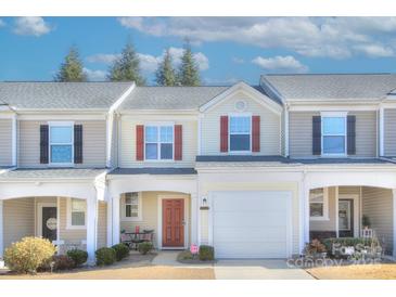 Tan and red three-story townhome with attached garage and landscaping at 206 River Clay Rd, Fort Mill, SC 29708