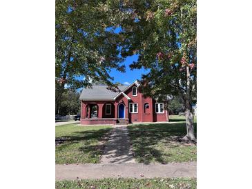 Brick home with a landscaped lawn and inviting front porch at 300 S Thompson St, Shelby, NC 28150