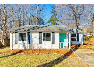 Charming one-story home with a bright teal door and classic black shutters at 4901 Smokehollow Rd, Charlotte, NC 28227