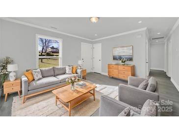 Bright living room with gray sofa and wood coffee table at 624 Gaywood Dr, Charlotte, NC 28273