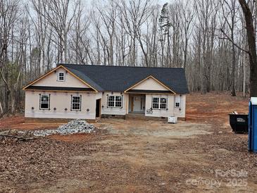 Newly constructed one-story house with a dark gray roof, nestled in a wooded area at 625 Shiloh Unity Rd, Lancaster, SC 29720