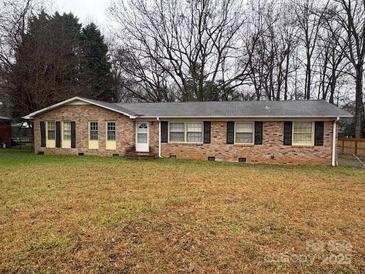 Ranch style brick home with mature trees and a spacious yard at 7119 Neal Rd, Charlotte, NC 28262