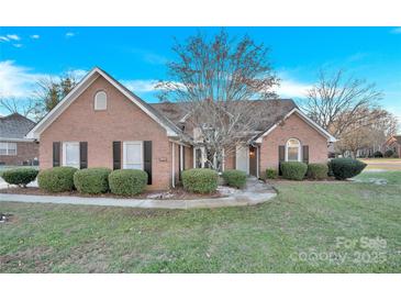 Brick house with landscaping, driveway, and a two-car garage at 1011 Emerson Dr, Mooresville, NC 28115