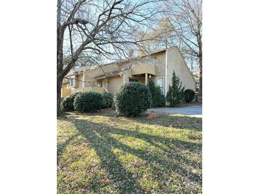 Tan two-story home with landscaping and trees in front at 1017 N Center Nw St, Hickory, NC 28601