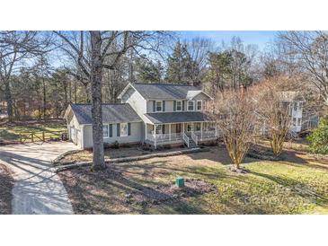 Two-story house with gray siding, porch, and a landscaped yard at 13010 Marlstone Ln, Charlotte, NC 28215