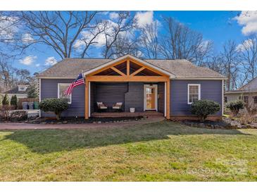 Charming renovated home with a welcoming front porch and landscaped lawn at 1334 Woodland Dr, Charlotte, NC 28205