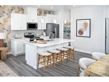 Modern kitchen with white cabinets, stainless steel appliances, and an island with seating at 2290 Hedgecliff Rd # 161, Kannapolis, NC 28025