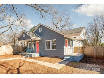 Gray house with pink door, fenced yard, and walkway at 2514 Ringwood St, Charlotte, NC 28208