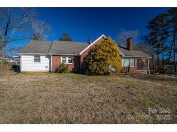 Brick ranch home with a large yard and mature trees at 327 S Grove St, Lincolnton, NC 28092