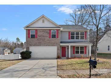 Two-story brick home with a white garage door and red accents at 709 Ferrell Ave, Charlotte, NC 28216