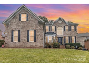 Brick two-story house with a landscaped yard and a two-car garage at 9729 Cockerham Ln, Huntersville, NC 28078