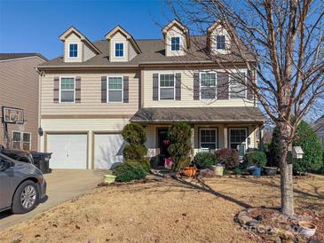 Two-story house with beige siding, two-car garage, and landscaping at 1147 Wagner Ave, Fort Mill, SC 29715