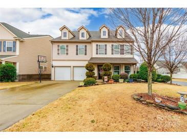 Two-story house with beige siding, two-car garage, and landscaped yard at 1147 Wagner Ave, Fort Mill, SC 29715