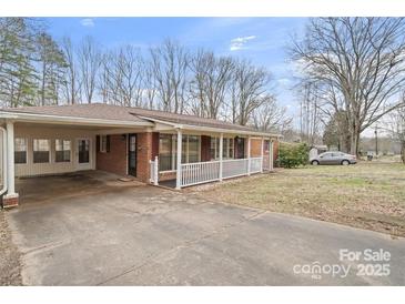 Charming single-story brick home featuring a covered carport and cozy front porch at 122 Lowry Row, York, SC 29745