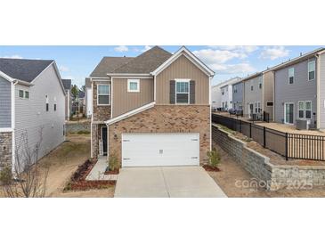 Two-story brick home with attached garage and landscaping at 310 Hyssop Ct, Fort Mill, SC 29715