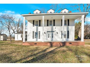 Two-story white house with a large front porch and brick steps at 550 Woodleaf Barber Rd, Cleveland, NC 27013