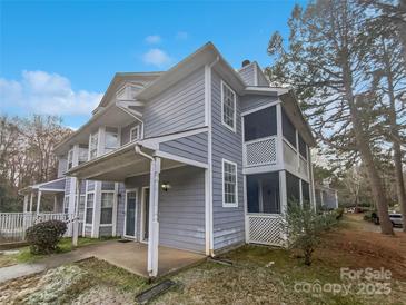 Gray two-story townhouse with front porch and screened balcony at 6041 Pinebark Ct, Charlotte, NC 28212
