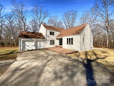 Two-story house with attached two-car garage and deck at 122 Cricket Creek Dr, Cherryville, NC 28021