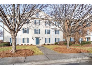 Two-story building exterior with blue shutters and a walkway at 3809 Carl Parmer Dr, Harrisburg, NC 28075
