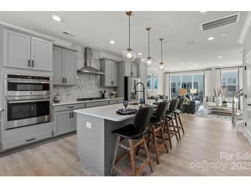 Modern kitchen with island, stainless steel appliances, and ample counter space at 5029 Westmead Ln, Charlotte, NC 28262