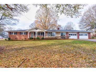 Brick ranch house with attached garage and mature trees at 1602 Eaves Rd, Shelby, NC 28152