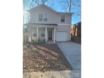 Two-story house with gray siding, white trim, and a double-car garage at 1827 Mcdonald St, Charlotte, NC 28216