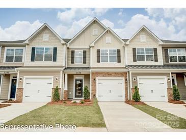 Two-story townhome with attached garage and landscaping at 4268 Black Ct # 229, Harrisburg, NC 28075