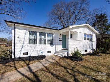 Charming brick home featuring a well-manicured lawn and inviting front entrance at 4837 Holbrook Dr, Charlotte, NC 28212