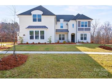 Beautiful two-story white brick home with a well-manicured lawn and appealing curb appeal at 6124 Music Arbor Ln, Huntersville, NC 28078