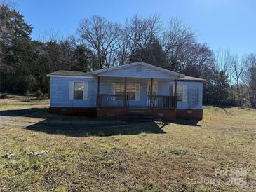 Ranch style mobile home with covered porch and spacious yard at 181 Jeter St, Chester, SC 29706