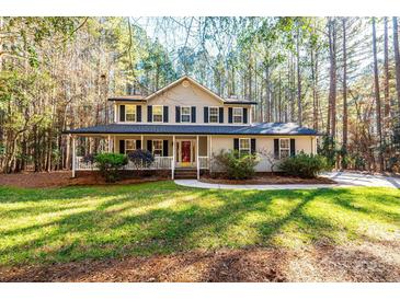 Two-story house with a wraparound porch and landscaped lawn at 165 Pine Valley Dr, Stanley, NC 28164