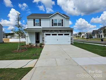 Two-story house with stone accents and a two-car garage at 177 Wembury Ln, Troutman, NC 28166