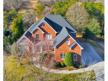 Brick home with large yard, driveway, and landscaping, seen from above at 2010 Lake Forest Dr, Fort Mill, SC 29708