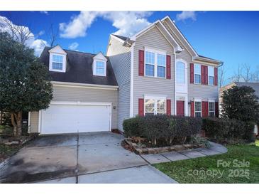 Two-story house with gray siding, red shutters, and a two-car garage at 4030 Garden Oak Dr, Indian Trail, NC 28079