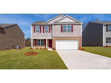 Two-story house with a red door and attached garage, fresh landscaping at 5149 Fireweed Ct, Dallas, NC 28034