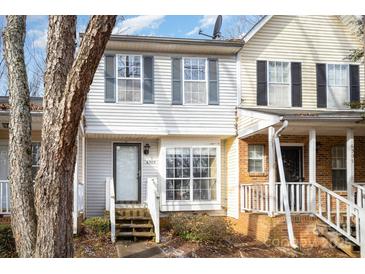 Inviting exterior of a charming townhome, featuring a brick facade and a welcoming front porch at 6303 Windsor Gate Ln, Charlotte, NC 28215