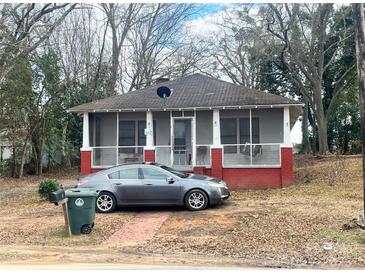 Charming red brick cottage with screened porch and mature trees at 1 Catawba Ave, Great Falls, SC 29055