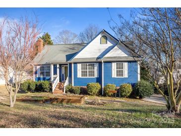 Charming blue house with white accents, landscaping, and a brick walkway at 117 Winghaven Ct, Mooresville, NC 28117